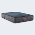 Hand pressing on Beautyrest World Class Hybrid mattress to show responsive medium support and pressure relief.
