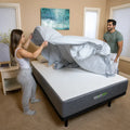 Couple making the bed with breathable GhostBed cooling sheets for a comfortable night's sleep.
