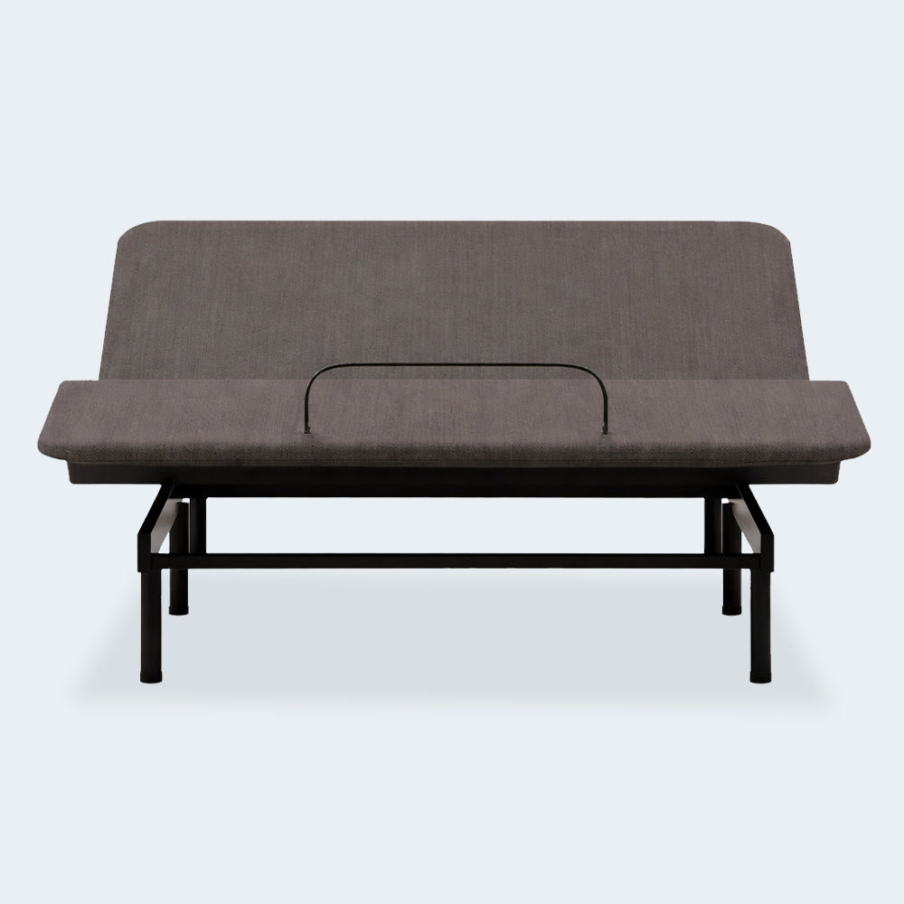 Front view of the Ashley Comfort Classic motorized bed base showing the head section raised and the mattress retainer bar.
