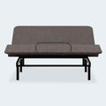 Front view of the Ashley Comfort Classic motorized bed base showing the head section raised and the mattress retainer bar.
