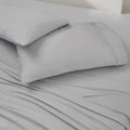 Close-up of two grey moisture-wicking Ver-Tex pillowcases and matching cooling bed sheets.
