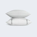 Stacked pillows with light gray BEDGEAR Hyper-Linen cases, providing a soft and airy feel for all-night comfort.
