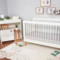 Grey BEDGEAR Hyper-Linen crib sheet on a modern white crib for temperature-neutral infant sleep.
