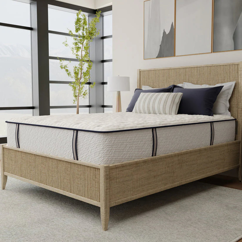 Three-quarter angle of the Sofinity Hybrid Signature firm 12-inch mattress highlighting its deep supportive profile and textured side panels.
