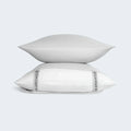 Stacked light gray BEDGEAR Hyper-Wool pillows featuring breathable, natural wool-blend fabric.

