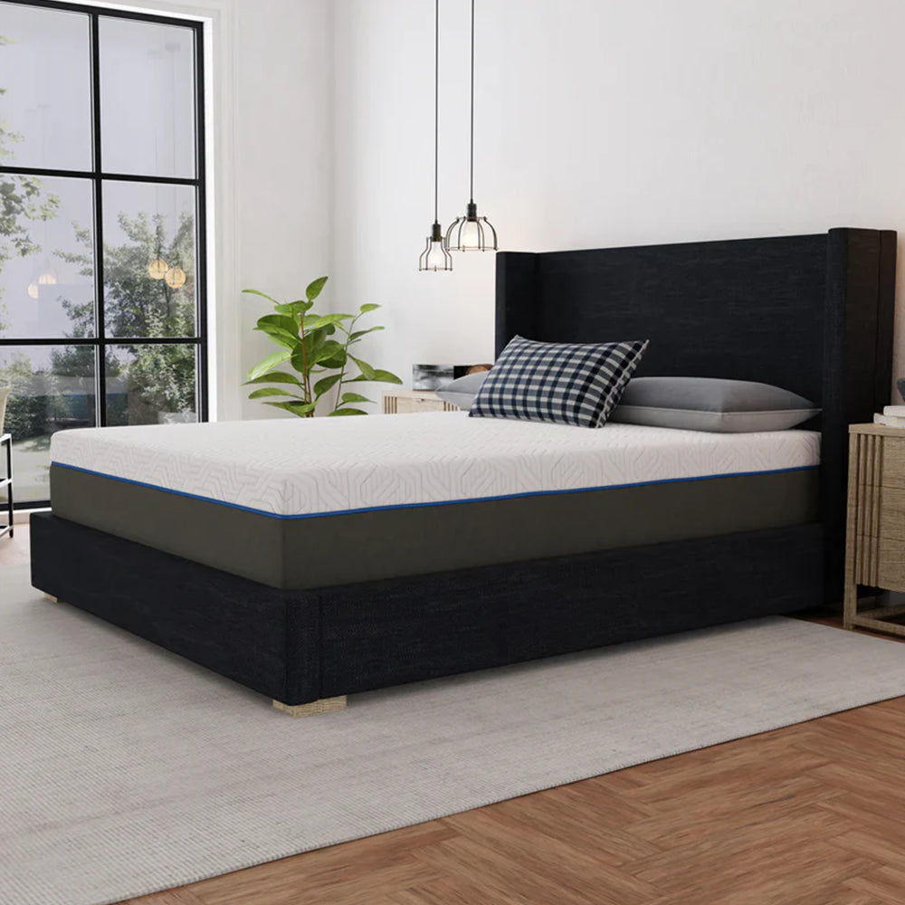 Three-quarter angle of the Lavender 12-inch firm mattress by South Bay highlighting the thick profile, blue accent piping, and charcoal grey base fabric.
