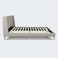 Side view of the South Bay Zoey upholstered platform bed frame featuring durable wooden slats and gold legs.
