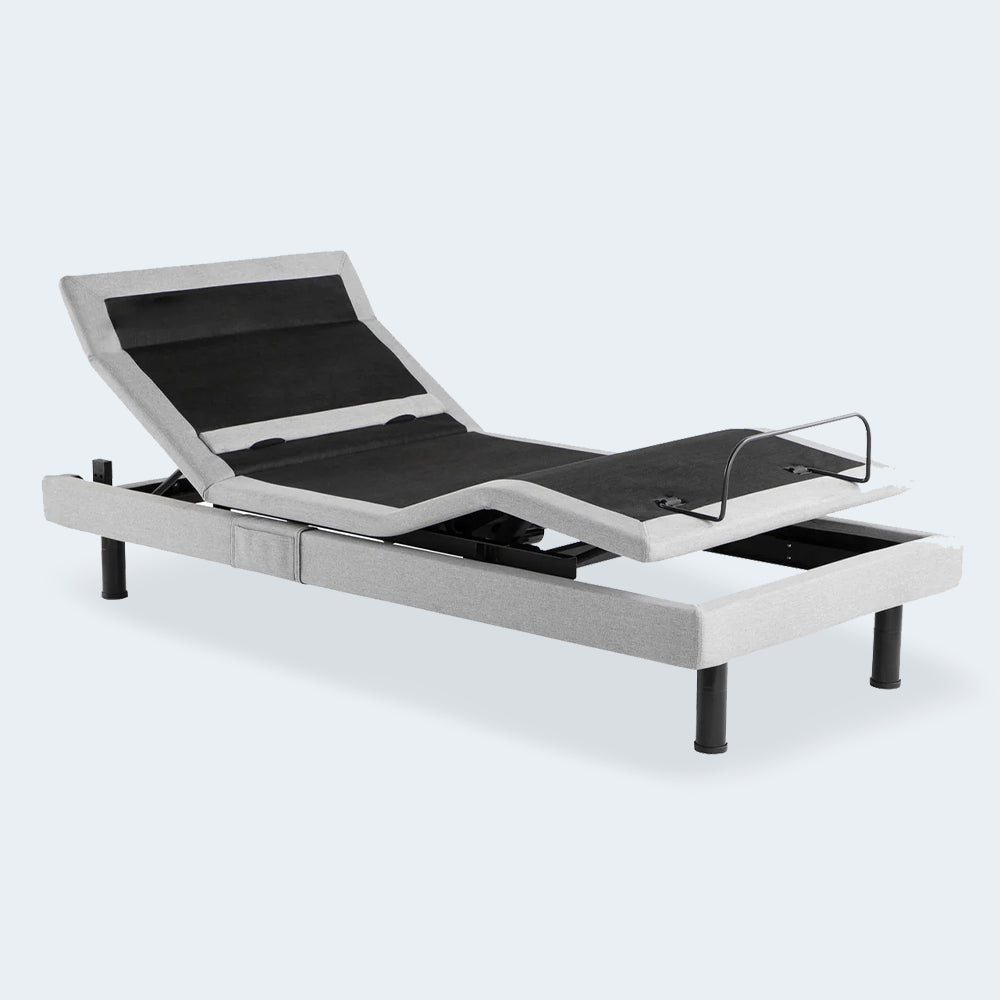Three-quarter perspective of the Malouf Structures S755 adjustable base showing articulated head and foot sections with light grey upholstery.
