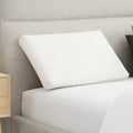 South Bay slim pillow for back and stomach sleepers, styled on a modern bed for spinal alignment.
