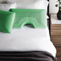 Green peppermint infused memory foam pillows with ergonomic shoulder cutouts for neck pain relief.
