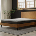 Three-quarter angle of the South Bay Essentials firm 8-inch mattress highlighting the grey quilted top and dark grey base on a stylish platform bed.
