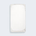 Underside view of the fitted organic cotton crib sheet showing the secure elastic for a snug mattress fit.
