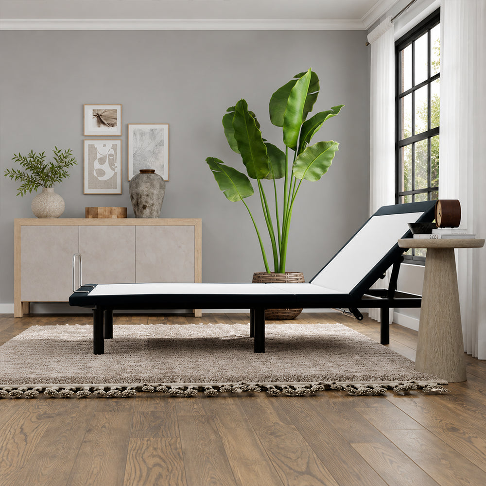 Low-angle lifestyle shot of the SBKDH Head up Adjustable Base in a minimalist room, showing the sleek profile of the raised head-up position.

