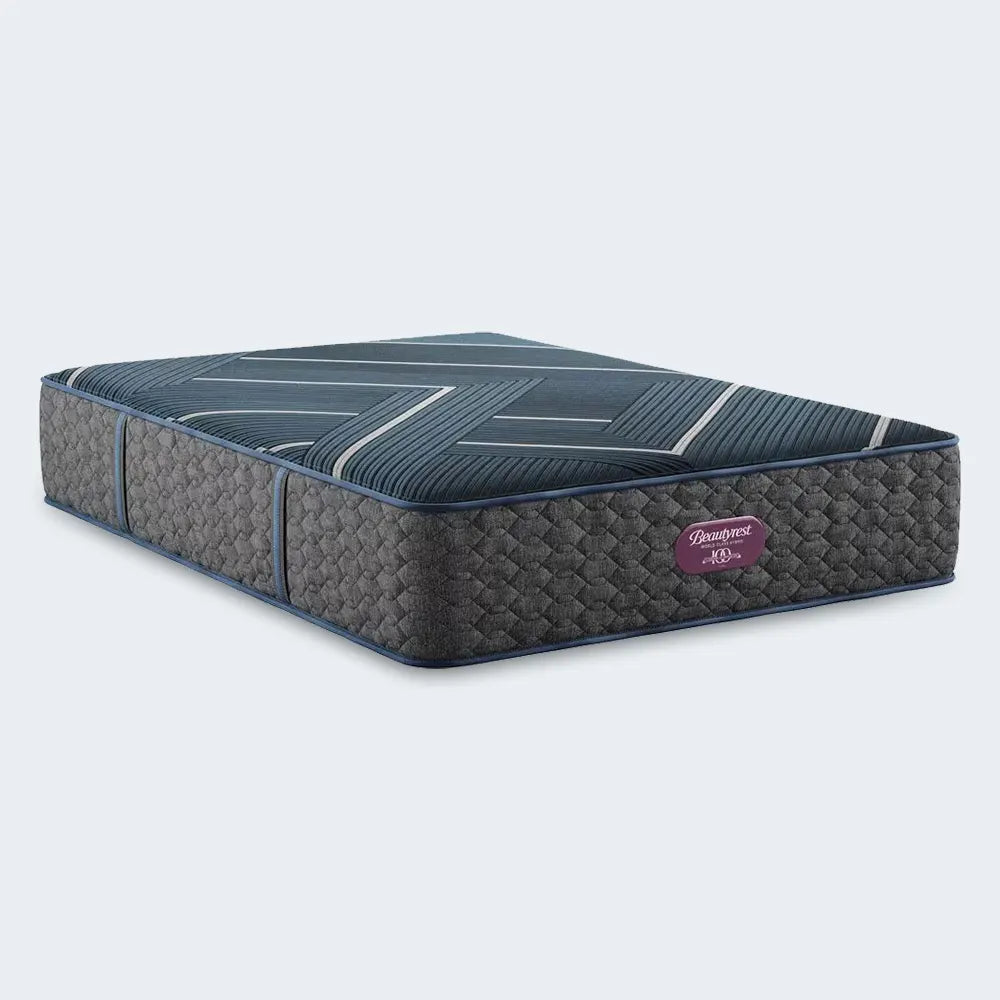 Lifestyle side view of the 13.5-inch Beautyrest World Class Level Four Hybrid mattress on a designer bed frame.
