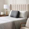 Ergonomic Malouf HexCurve memory foam pillow on a bed for side sleeper neck and shoulder alignment.
