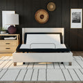 Front view of the SBKD3 zero-clearance adjustable base fitted inside an upholstered bed frame, showing the head-up position for reading or lounging.
