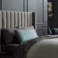 Ventilated carbon-infused memory foam pillow on a bed providing heat-dissipating sleep and neck support.
