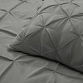 Detailed pintuck texture of the SleepTone charcoal down alternative comforter and matching pillow sham.
