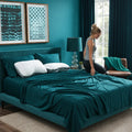 Pair of BEDGEAR Storm performance pillows on a luxury teal bed for supportive, cool sleep.
