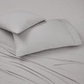 Set of two gray BEDGEAR Ver-Tex pillowcases on a bed, designed with heat-deflecting cooling technology.
