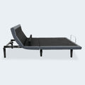 Side view of the Customatic Opus smart bed showing the actuator-driven neck tilt and adjustable lumbar back support.
