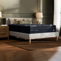 Modern bedroom interior featuring the DreamCloud Luxe 14-inch hybrid mattress styled on a minimalist upholstered platform bed frame.

