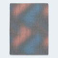 Direct top-down view of the Hot Buy 13 Inch Firm Hybrid Mattress surface featuring a unique geometric blue and peach textured performance cover.