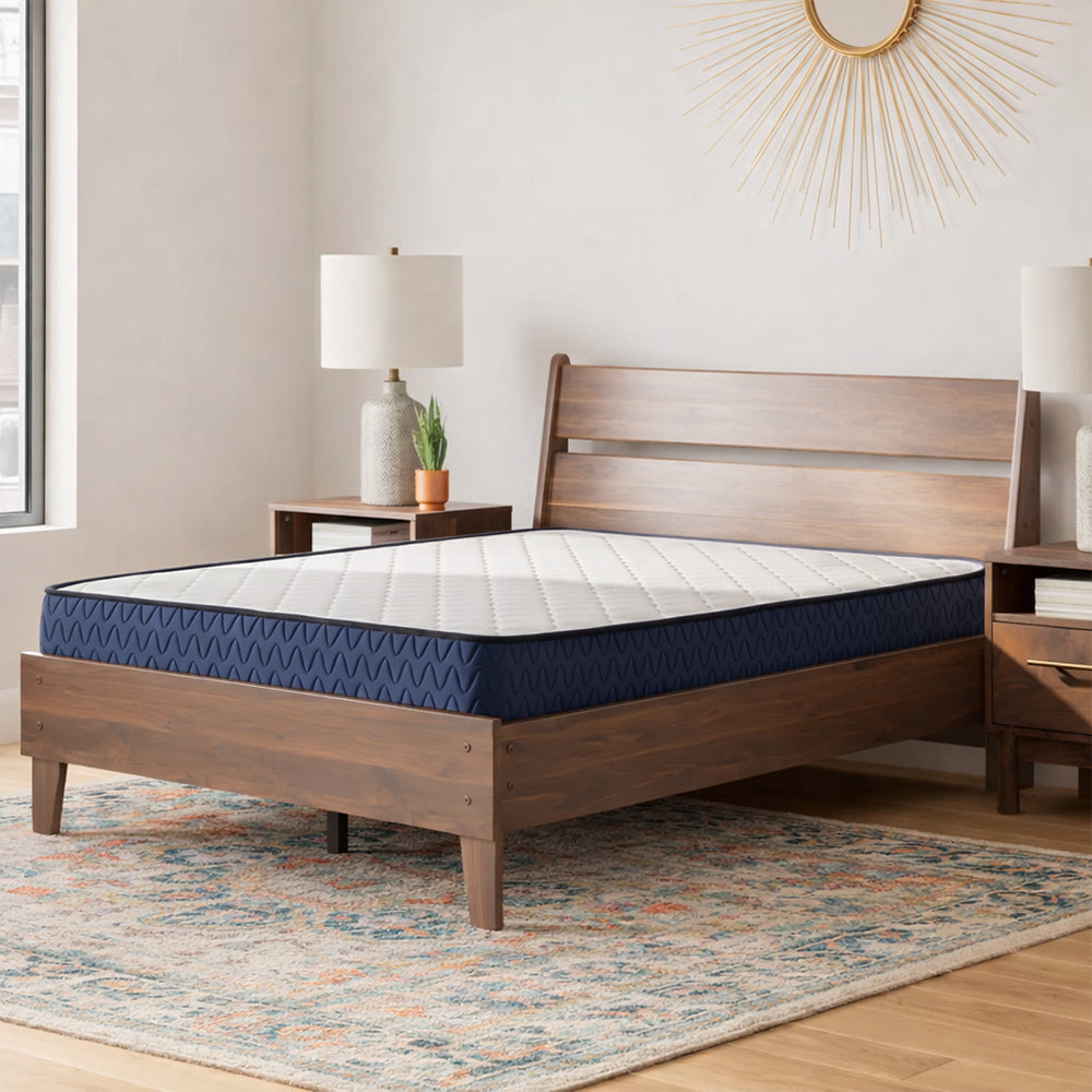 Firm 6-inch Mattress by Ashley styled on a mid-century modern dark wood platform bed frame with contemporary decor.
