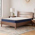 Firm 6-inch Mattress by Ashley styled on a mid-century modern dark wood platform bed frame with contemporary decor.
