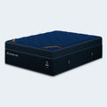 Side angle perspective of the DreamCloud Ultra 15-inch hybrid bed highlighting the cooling mesh side panels and premium navy blue fabric.
