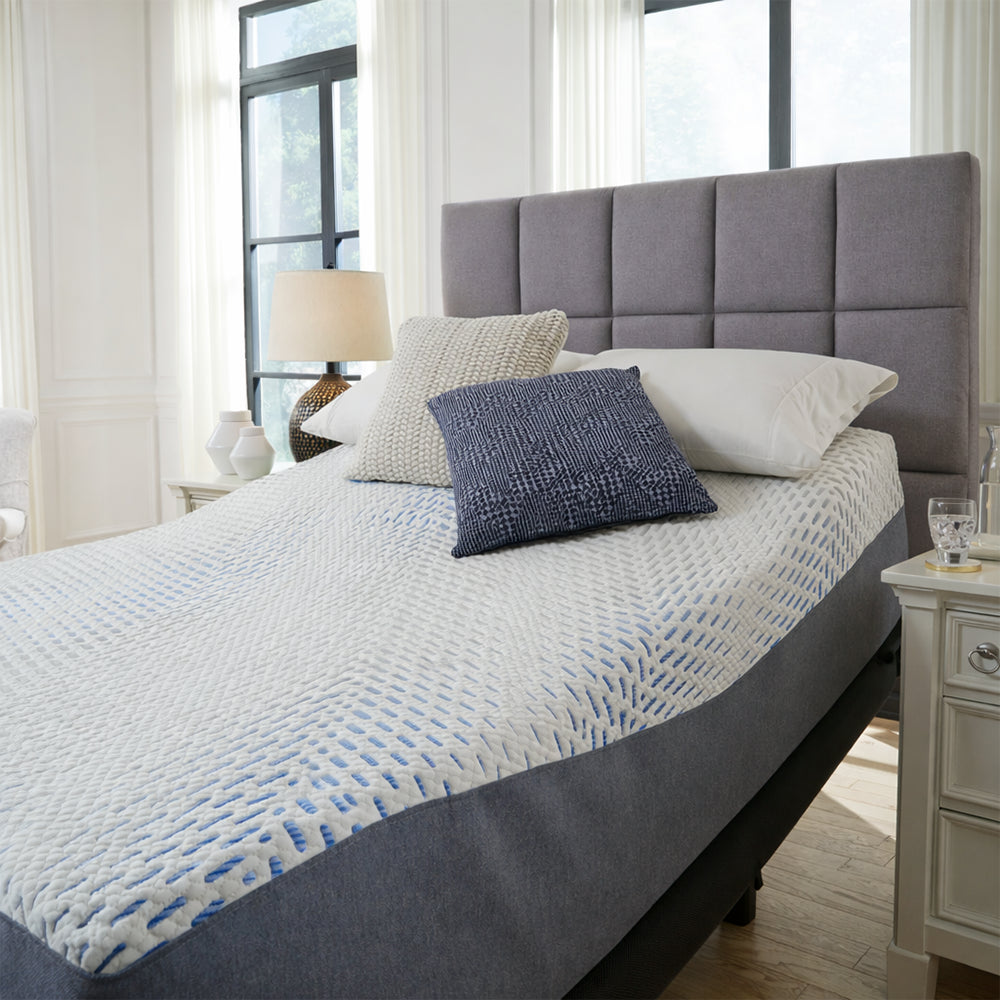 Symmetrical front view of the Millennium Luxury Gel Memory Foam Mattress by Ashley in a luxury bedroom, designed for superior cooling and motion isolation.
