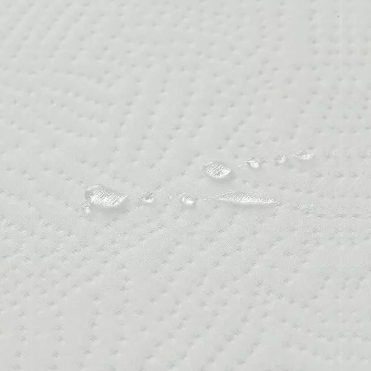 Close-up of water droplets on the water-repellent cover of this Organic Hybrid Crib Mattress.