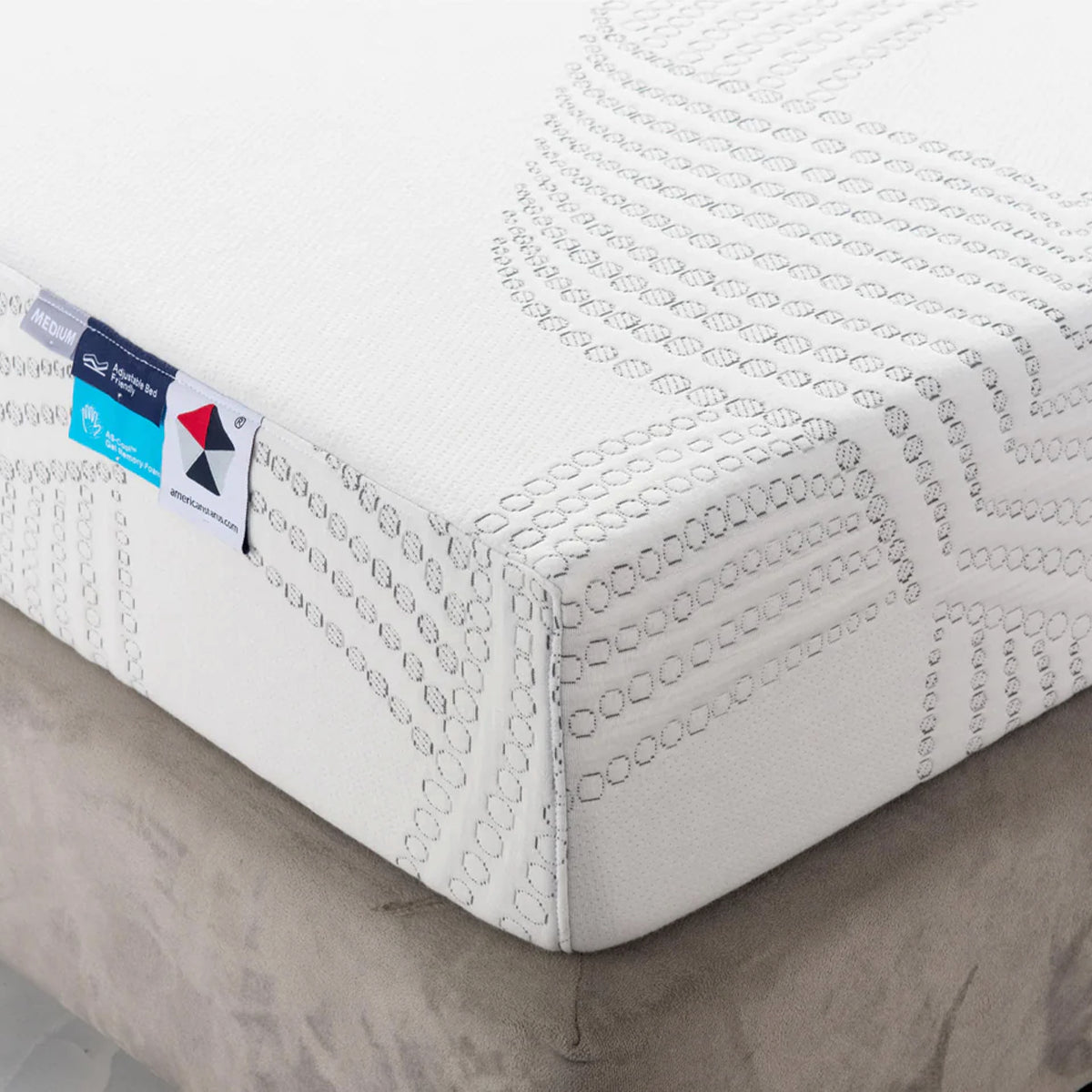 Close-up of the 8” Medium Cool Gel Memory Foam Mattress corner with a soft knitted cover and adjustable bed tag.