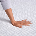 Hand pressing into the Gel Memory Foam Mattress Topper to demonstrate soft contouring and pressure relief.