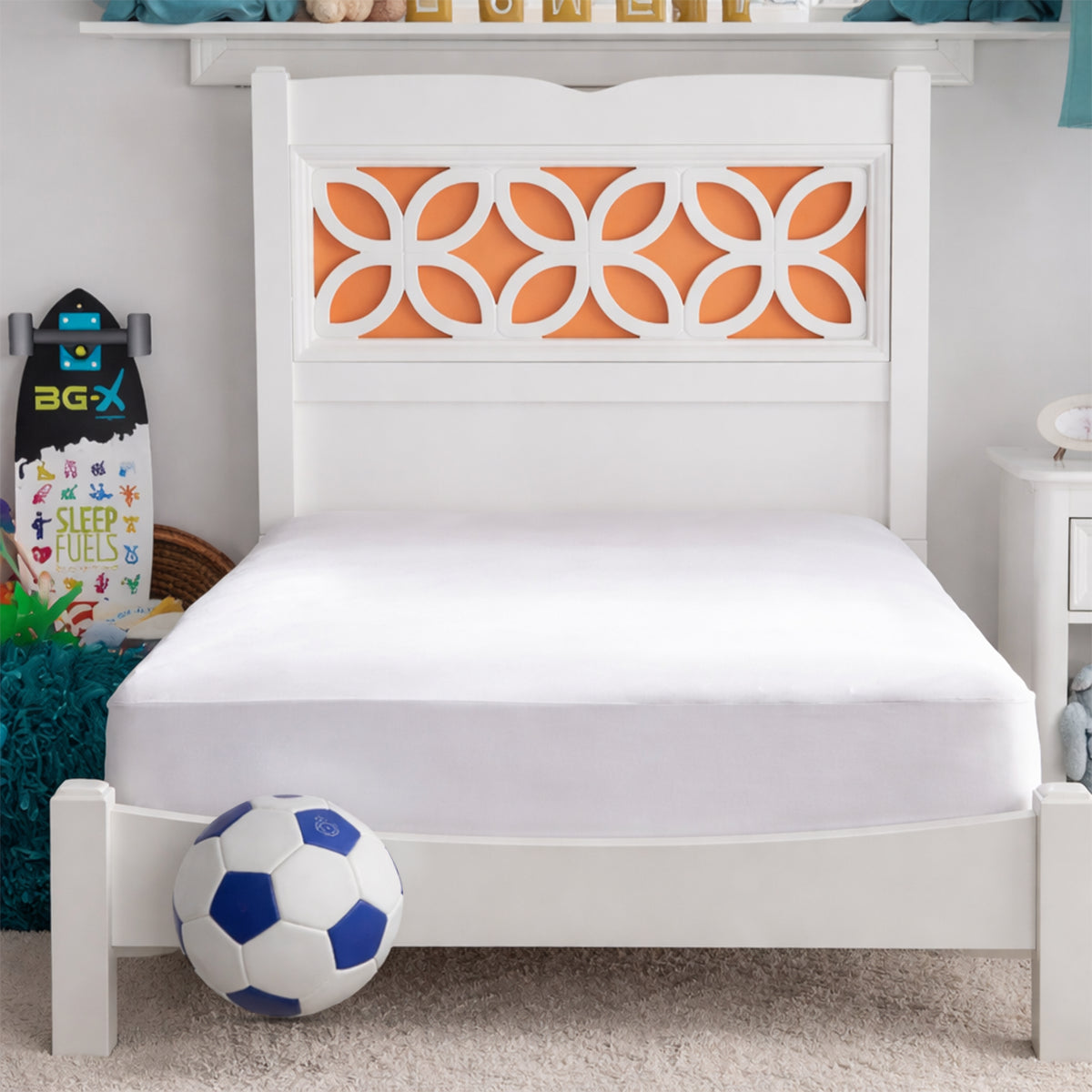 Basic Kids Mattress Protector in a bright bedroom setting on a white twin bed with a soccer ball in the foreground.