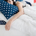 Lifestyle shot of a sleeper on the WinkBeds Blue 17" Mattress emphasizing the plush luxury firm latex comfort.
