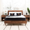 Front view of the 13.5 Inch Pillow Top Mattress in bedroom setting styled with a modern natural wood platform frame.