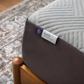 Detailed close-up of the Neve with ActivAir product tag on the corner of a Malouf 12-inch luxury all-foam mattress.
