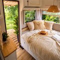 Frontal view of the GhostBed RV 10-inch hybrid mattress and GhostPillows setup in a camper van for maximum utility.
