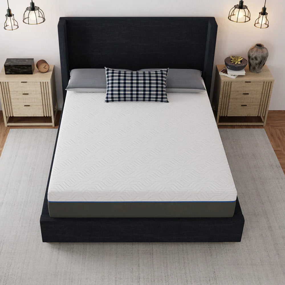 High-angle shot of the Lavender 12-inch mattress showing the breathable geometric patterned white cover on a black platform bed.
