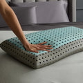Hand pressing responsive Malouf CarbonCool memory foam showing plush support and advanced cooling technology.
