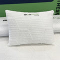 Close-up of the GhostPillow shredded cluster pillow logo and cooling fabric on a premium mattress.
