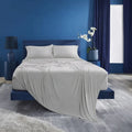 Grey BEDGEAR Ver-Tex sheet set on a modern bed in a stylish blue bedroom for ultimate cooling.
