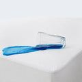 Spilled liquid on a white Weekender Jersey Mattress Protector demonstrating its 100% waterproof surface.
