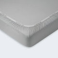 Secure Powerband elastic on a grey BEDGEAR Dri-Tec crib sheet for a safe, snug fit.
