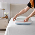 Removable and washable cooling pillow cover being adjusted on a Sleeptone memory foam pillow.
