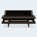 Front view of the Comfort Ultra Adjustable Base by Ashley with the head elevated, highlighting the mattress retainer bar and upholstered frame.
