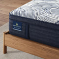 Close-up of the Serta Perfect Sleeper Pro Edinburgh 15 inch plush mattress corner and quilted hybrid texture.
