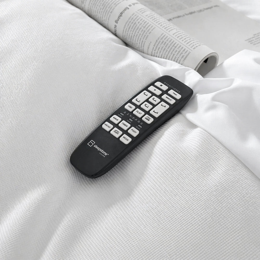 Detailed close-up of the SleepTone S5000 wireless remote featuring one-touch presets for zero gravity, anti-snore, and multi-speed massage.
