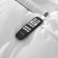 Detailed close-up of the SleepTone S5000 wireless remote featuring one-touch presets for zero gravity, anti-snore, and multi-speed massage.
